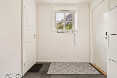 a hallway with a door and a window at Trolltunga Fjord Living in Tysso