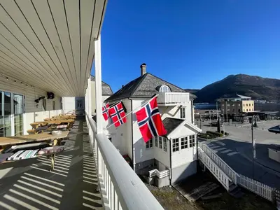 two british flags on the balcony of a building at Jibben Hotell in Måløy