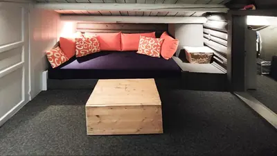 a bunk bed with a bench in a room at Hytta Idyll in Dagali