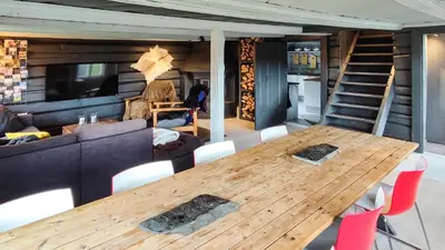 a living room with a wooden table and a couch at Hytta Idyll in Dagali