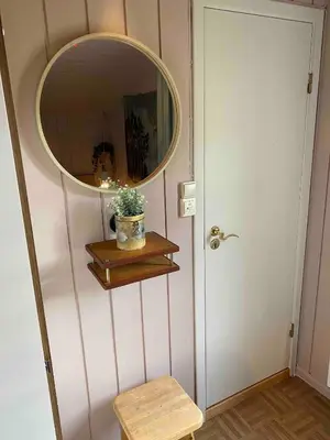 a mirror on a wall next to a door at Newly renovated cabin near Ål city center, mountains & ski resort in Liagardane