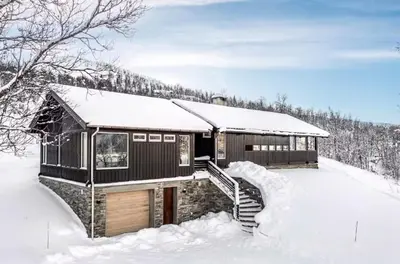 a cabin in the snow with snow covered ground at 70S Architectural Cabin With Views In Hemsedal in Hemsedal