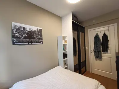 a bedroom with a bed and a picture on the wall at Bergen City Center Apartment in Bergen