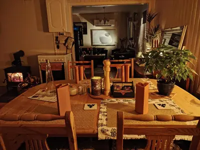 a wooden table with chairs and a tablecloth on it at Landgård Feriehus in Trysil
