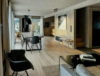 a living room with a table and a dining room at Modern Cabin With Ski In Out At Kvitfjell in Favang