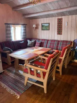 a living room with a table and a couch at Traditional Cabin In Nøsterbølia in Uvdal