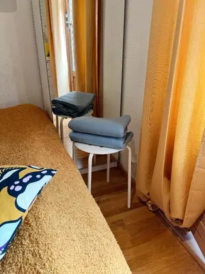 a room with two chairs and a bed and a mirror at Du vil elske å bo her! Et lite, men koselig sted med perfekt beliggenhet! in Trondheim
