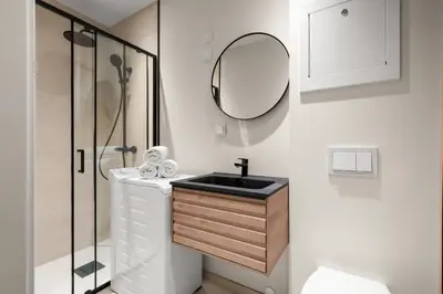 a bathroom with a sink and a mirror at Bergen Beds Apartments I Urban Escape in Bergen
