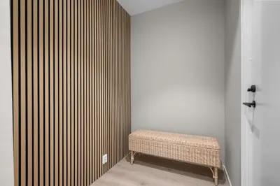 a bench sitting in a corner of a room at Bergen Beds Apartments I Urban Escape in Bergen