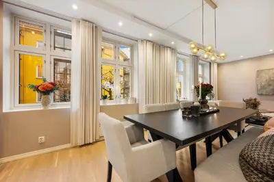 a dining room with a table and chairs at Luxury Summer Apartment with Balcony Near Bryggen in Bergen
