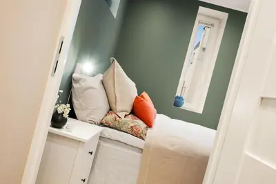 a room with a bench with pillows on it at Luxury Summer Apartment with Balcony Near Bryggen in Bergen