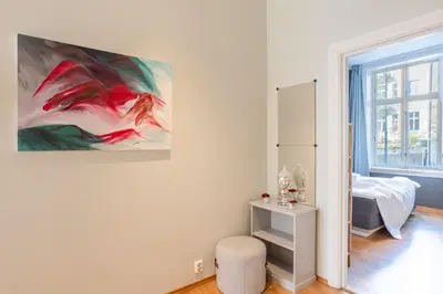 a white room with a painting on the wall at Roomsly Apartments - Prime Location and Modern Comfort in Bergen