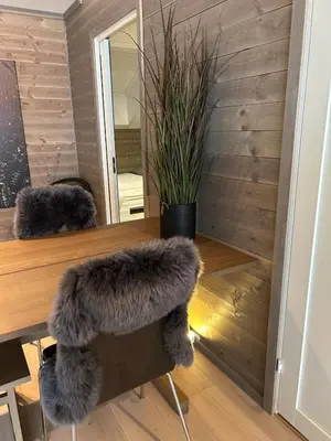 a room with a table with a faux fur chair at Gorgeous apartment in Geilo in Hol