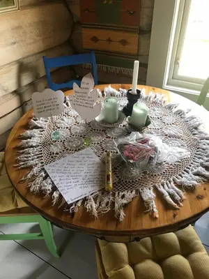a table with candles and papers on top of it at Charming lodge from 1888 in Sel