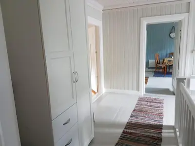 a room with a white cabinet and a dining room at Large Family Friendly Apartment in Lillehammer