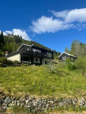 a house sitting on top of a grassy hill at Idyllic houses in quiet surroundings in Vossevangen