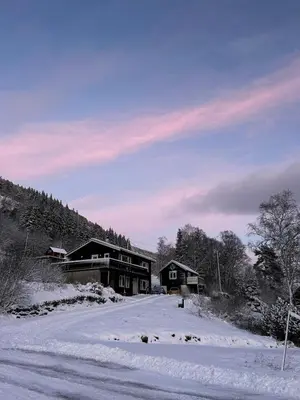a house in the snow in front of a road at Idyllic houses in quiet surroundings in Vossevangen
