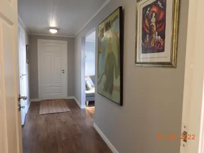 a hallway with a painting on the wall and a picture at House with all amenities for rent in Steinkjer