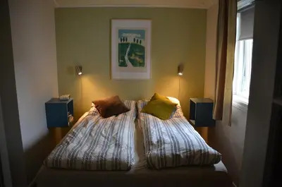 a bedroom with a bed with two pillows on it at House with all amenities for rent in Steinkjer