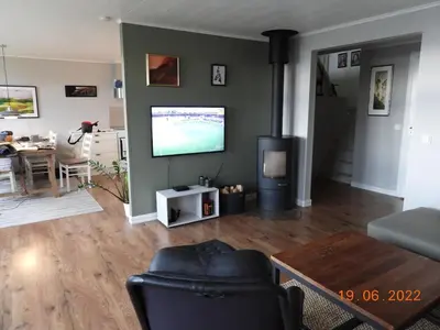 a living room with a flat screen tv on a wall at House with all amenities for rent in Steinkjer