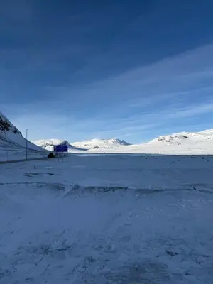 a snow covered field with a fence and snow covered mountains at Storehorn apartments, Hemsedal - 2 bedrooms, 5 beds in Torset