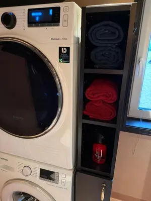 a washing machine with a microwave in a room at Cozy Apartment in Melhus in Melhus