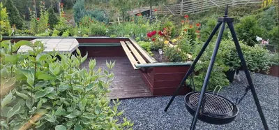 a garden with a wooden deck and some plants at Cabin Room on DaVita Ranch in Tranhaug