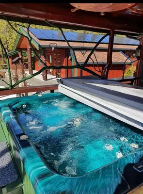 a pool of water with a bed on a boat at Cabin Room on DaVita Ranch in Tranhaug