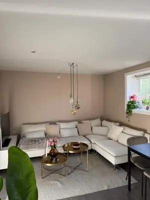 a living room with a white couch and a table at Cozy apartment near city center and the mountains in Bergen