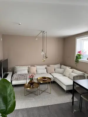 a living room with a white couch and a table at Cozy apartment near city center and the mountains in Bergen