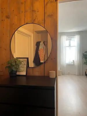 a mirror on a wooden wall in a room at Modern and Cosy apartment in Bergen City Centre in Bergen