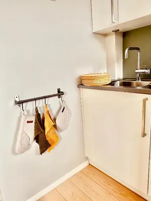 a kitchen with a sink and a towel rack at Stylish free parking Studio central with balcony in Ålesund