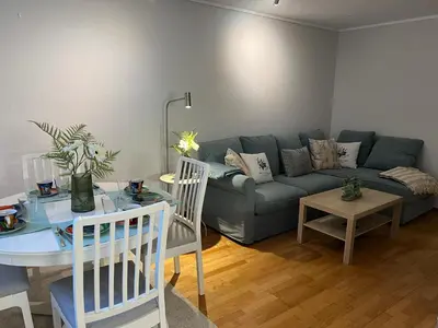a living room with a couch and a table at Cozy flat in the heart of Bergen in Bergen