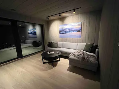 a living room with a couch and a table at The Panoramic Chalet in Stranda