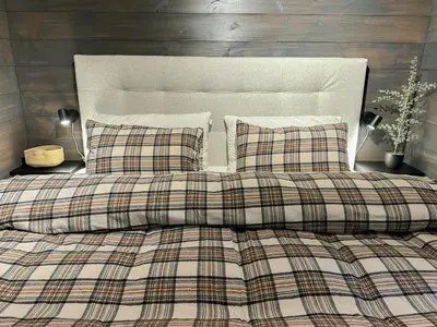 a bed with two pillows and a plaid blanket at Modern Apartment At Strandafjellet Ski Resort in Stranda