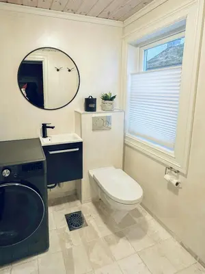 a bathroom with a toilet and a sink and a mirror at Modern Apartment At Strandafjellet Ski Resort in Stranda