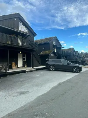 a black car parked in front of a house at Modern Apartment At Strandafjellet Ski Resort in Stranda