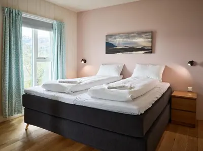 a large bed in a room with a window at Villa Fjord View in Stranda