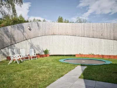 a backyard with two chairs and a trampoline at Villa Fjord View in Stranda