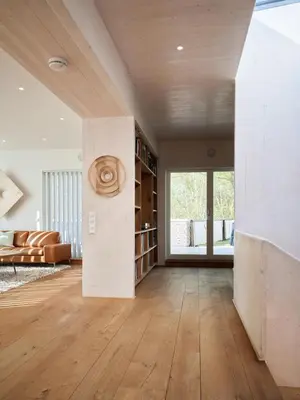 a living room with white walls and wooden floors at Villa Fjord View in Stranda