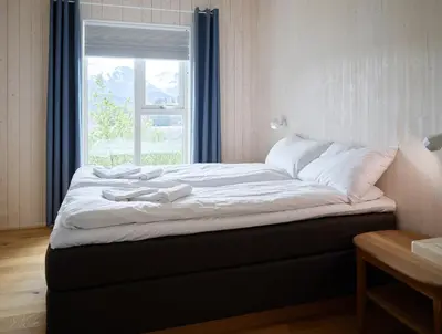 a large bed in a room with a window at Villa Fjord View in Stranda