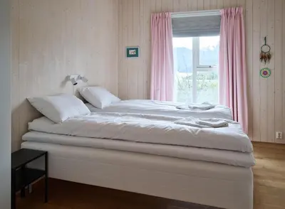 a bed in a room with a window at Villa Fjord View in Stranda