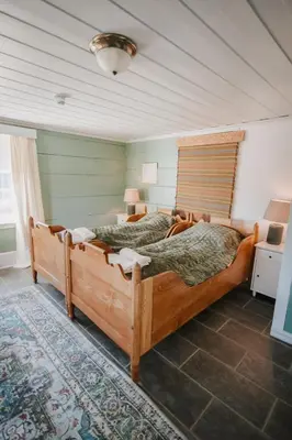 a bedroom with a large wooden bed in a room at Helgaker Gård in Gran