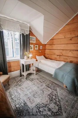 a small bedroom with a bed and a table at Helgaker Gård in Gran