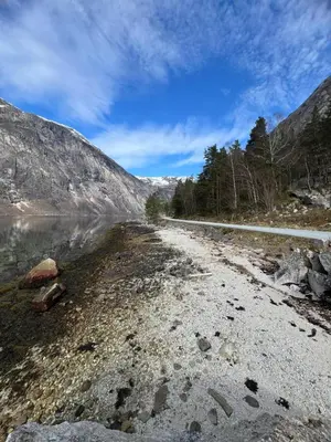 a dirt road next to a body of water at Eidfjord Fjell in Eidfjord