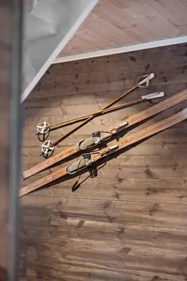 a bunch of skis on the ceiling of a room at Ny, stor hytte nær Røros sentrum! in Røros