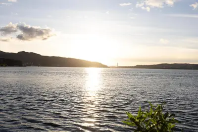 a view of the sun setting over a large body of water at Heimby Homes - Balcony above the sea in Bergen