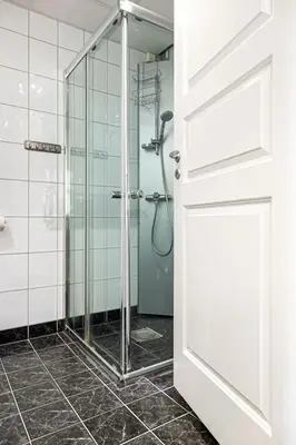 a bathroom with a shower with a glass door at Heimby Homes - Balcony above the sea in Bergen