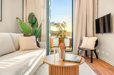 a living room with a couch and a table at Heimby Homes - Balcony above the sea in Bergen