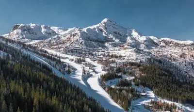 a snow covered mountain with trees and a resort at Apartment in Hemsedal in Hemsedal